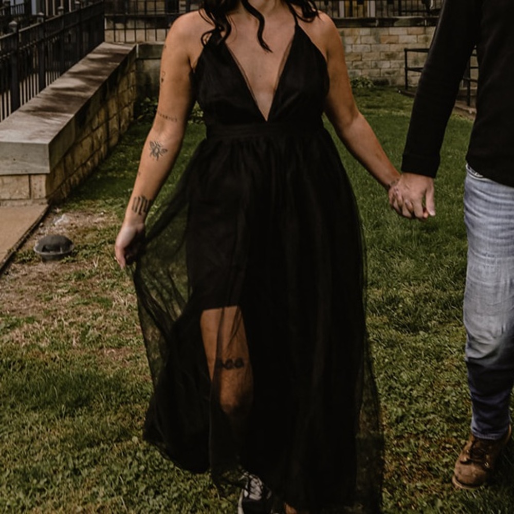 black dress, ball gown bottom, backless thong cross cross back straps.